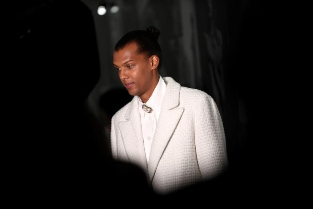 (FILES) In this file photo taken on October 4, 2022 Belgian singer-songwriter Stromae arrives at the Chanel  Spring-Summer 2023 fashion show as part of the Paris Womenswear Fashion Week, in Paris. Belgian singer, composer and producer Paul Van Haver aka Stromae, sick, announced on April 4, 2023, the cancellation of all his concerts until the end of May. (Photo by JULIEN DE ROSA / AFP)