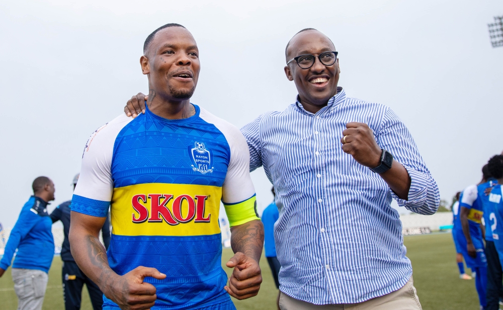 Rayon Sports skipper Abdoul Rwatubyaye with a team supporter celebrate the 1-0 victory over APR FC at Huye stadium. The captain has said that the club have not given up on league title hopes. Olivier Mugwiza