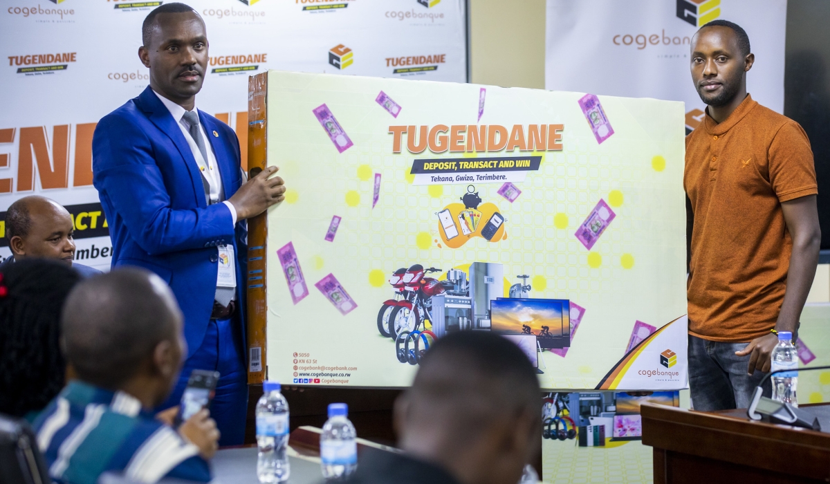 One of the winners receives a flat screen during the awarding ceremony. ‘Tugendane na Cogebanque 2023’ campaign, in Kigali on April 4. All Photos by Olivier Mugwiza