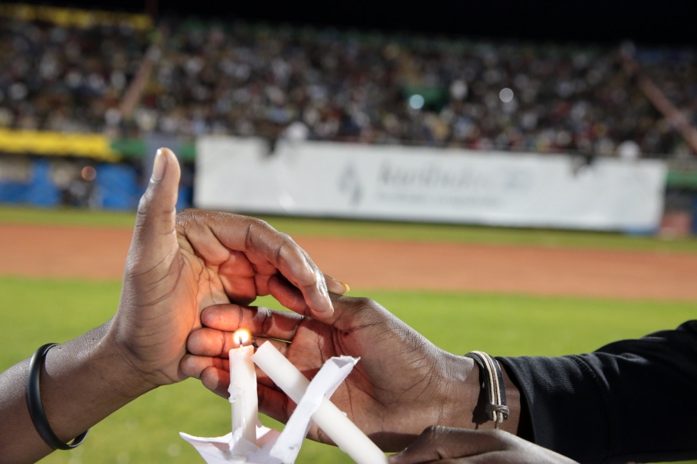 Mourners light candles during a past  commemoration event. According to the Ministry, the upcoming commemoration will be held under the theme “Kwibuka twiyubaka Remember-Unite-Renew.”.