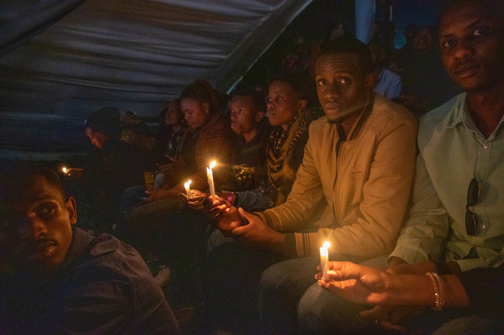 Mourners with lit candles during a commemoration event of the 1994 Genocide against the Tutsi at Kigali Genocide Memorial on Sunday, April 9. Dan Gatsinzi