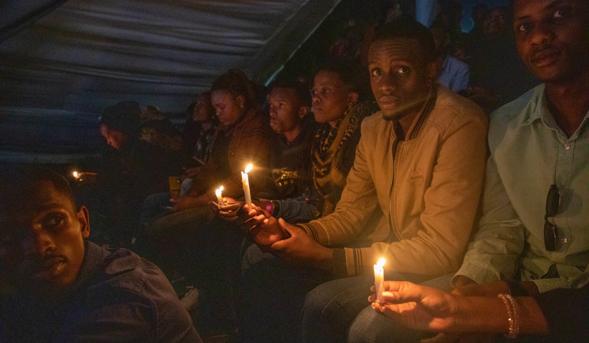 Mourners with lit candles during a commemoration event of the 1994 Genocide against the Tutsi at Kigali Genocide Memorial on Sunday, April 9. Dan Gatsinzi