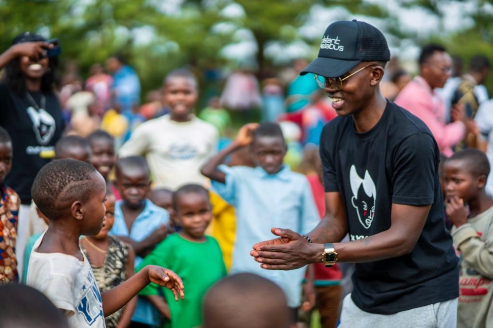 Christian Intwari plays with children during an event organised by Our Past Initiative. Photo: Courtesy.