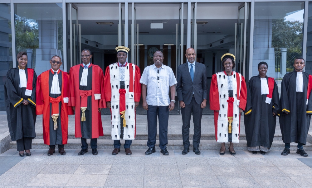Senior officials, including Prime Minister Edouard Ngirente (centre) ,Prosecutor General Aimable Havugiyaremye( 4th Left) and Justice minister Emmanuel Ugirashebuja (4th right) pose for a group photo with four newly sworn in prosecutors in Kigali, on Wednesday, April 12.