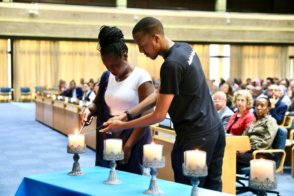 Representatives of the youth lighting candles as a sign of hope after the country&#039;s tragic history.