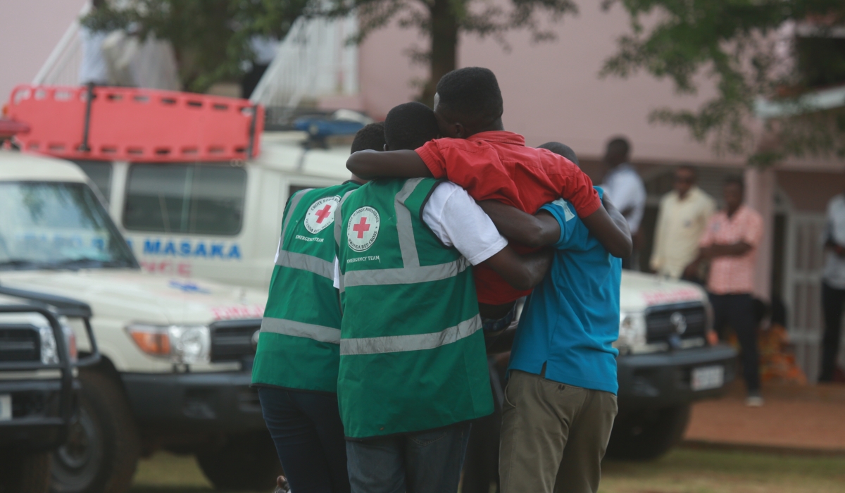 Youth carry a trauma victim during the decent burial at Nyanza Kicukiro Genocide memorial. Sam Ngendahimana