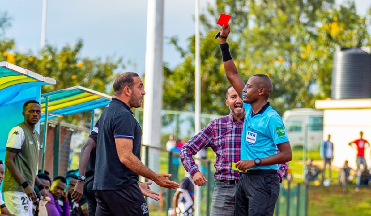 Referee Ruzindana Nsoro show a red card to APR assistant coach Eddine Neffati after throwing a jacket away protesting his refereeing call during club’s goalless draw with Gasogi on Saturday, April 15. Photo IGIHE