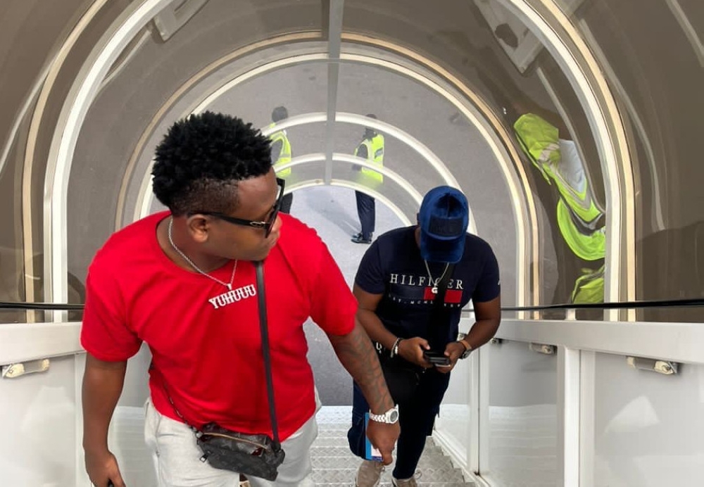 Bruce Melodie and his manager Coach Gael are pictured boarding in at Kigali International Airport ahead of their music tour in Nigeria. Courtesy