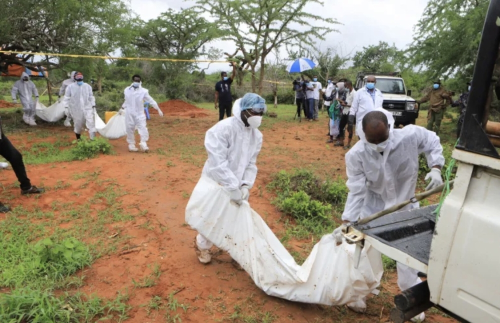 Forensic experts and homicide detectives carry the bodies of suspected members of a Christian cult named as Good News International Church (Courtesy Photo)