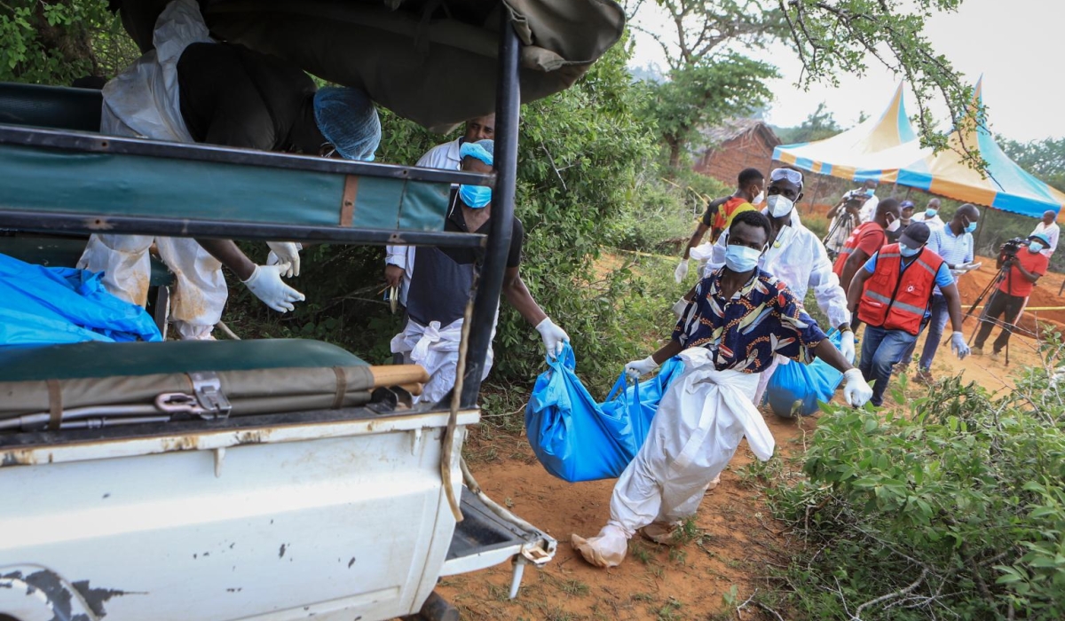 Police and local residents load the exhumed bodies of victims of a religious cult into the back of a truck in the village of Shakahola, near the coastal city of Malindi, in Kenya on April 23, 2023.