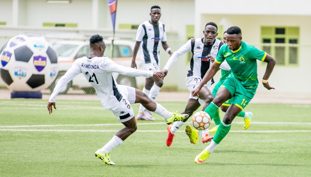 APR players trying to stop Marine&#039;s opponent. The two teams faceoff in a Peace Cup quarter final second leg encounter on Tuesda at Umugnda Stadium-File