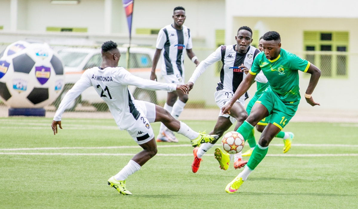 APR players trying to stop Marine&#039;s opponent. The two teams faceoff in a Peace Cup quarter final second leg encounter on Tuesda at Umugnda Stadium-File