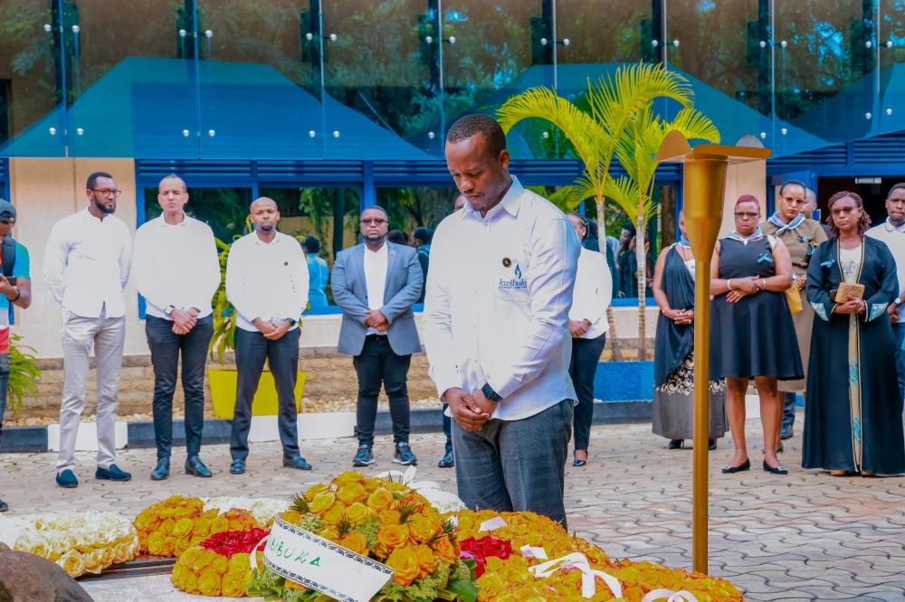 RSSB CEO Regis Rugemanshuro inclines to pay tribute to the 19 former members of staff of the then social security fund of Rwanda, at a monument erected in their memory at RSSB headquarters in Kigali, on April 28, 2023 (courtesy)