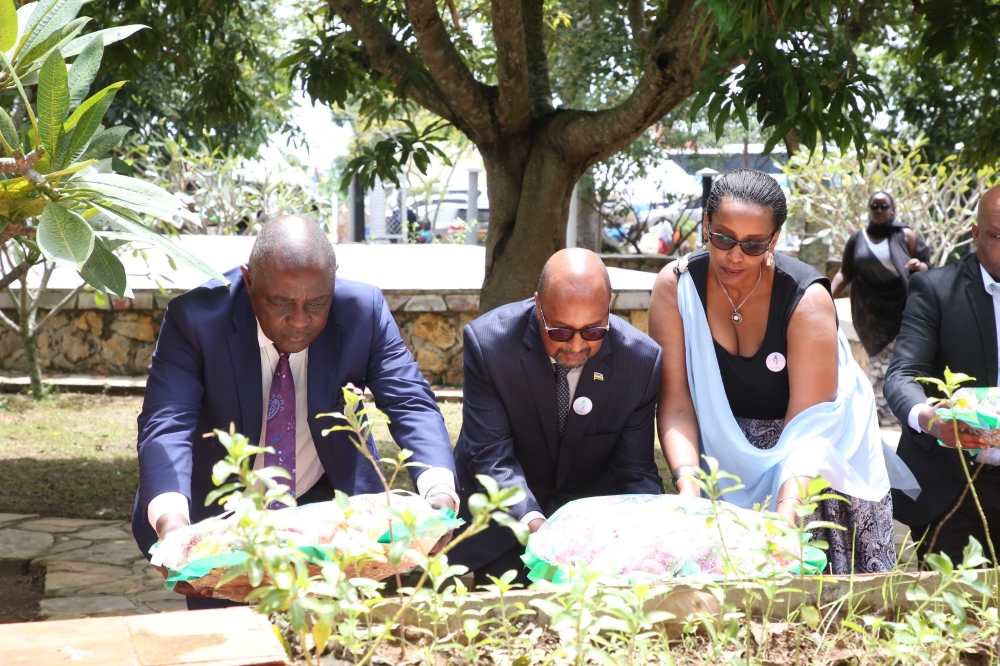Uganda's Defence Minister Vincent Bamulangaki Sempijja was joined by Rwanda's High Commissioner to Uganda Col. Joseph Rutabana and his wife in laying wreath on one of the mass graves at Lambu Genocide site.
