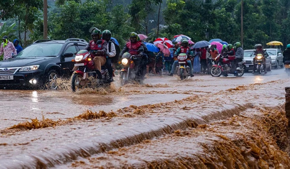 Taxi-moto operators and vehicles wade through a flooded street in Kigali on May 2, 2023. The weather forecast, released on May 2, states that the first 10 days of May 2023 are expected to be wetter than usual. File 