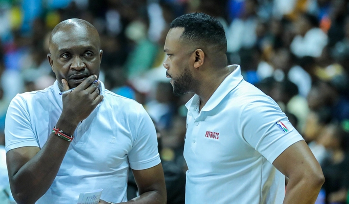 former Patriots head coach Bernard 'Ben' Oluoch head coach (left) and Jean Claude Mukurarinda, the team manager, consult during a past match last year. Courtesy
