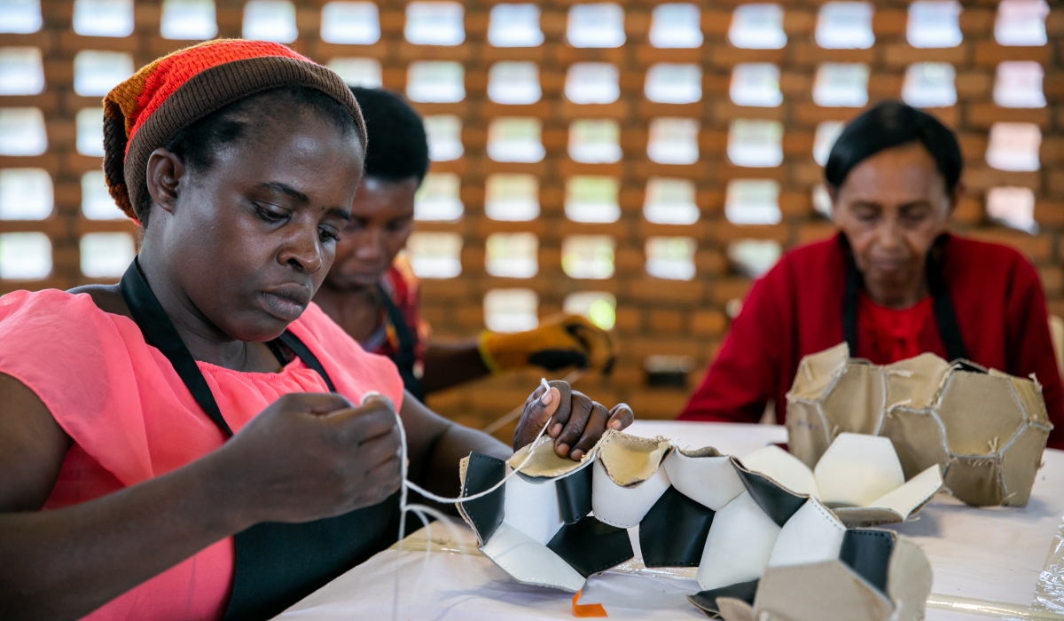 Some of the women who make soccer balls busy at work. All photos: Olivier Mugwiza.