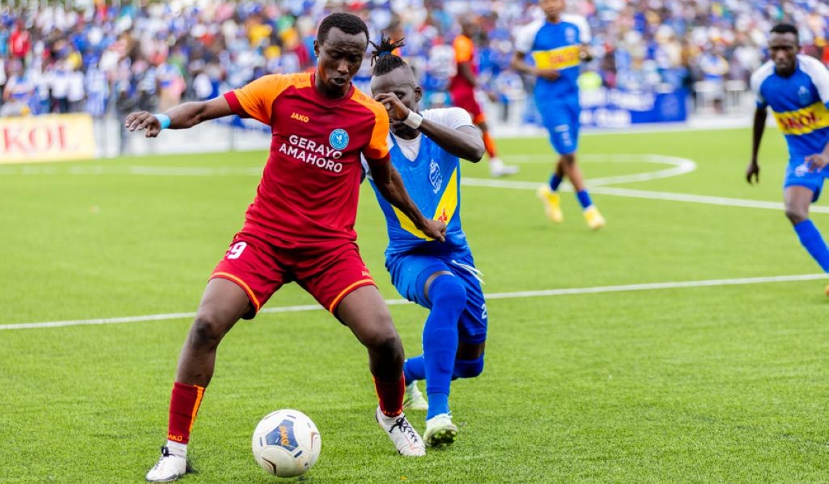 Police striker Didier Mugisha (left) vies for the ball against a Rayon Sports opponent. The fast-rising
attacker has been one of standout players in the second round of Rwanda Premier League. Photo: File.