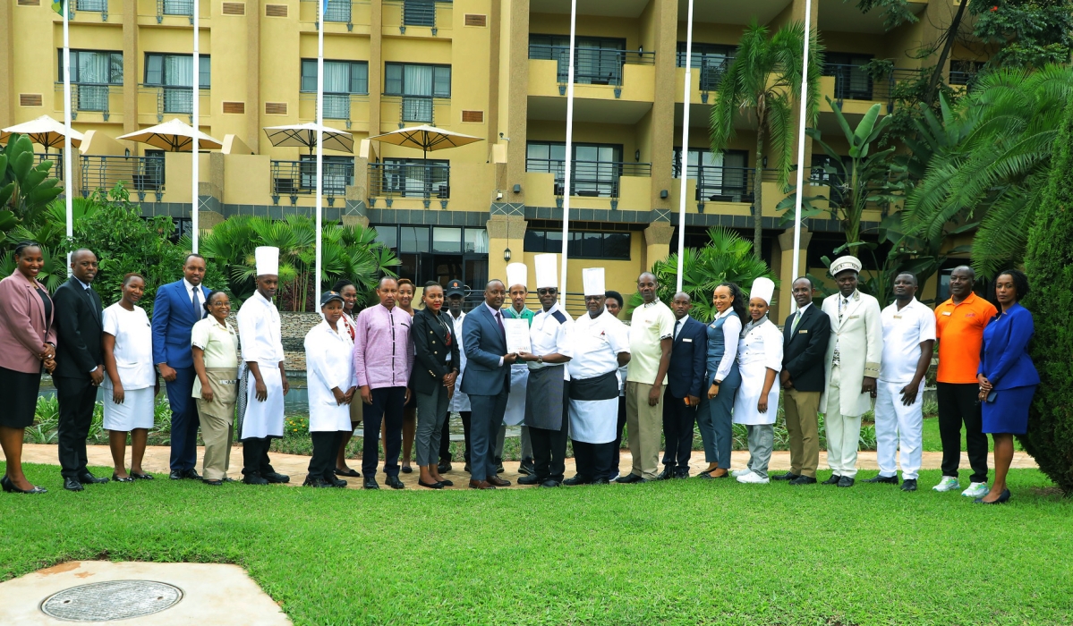 Staff and Management of Serena Hotel pose for a group photo after celebrating the newly recieved cerificate