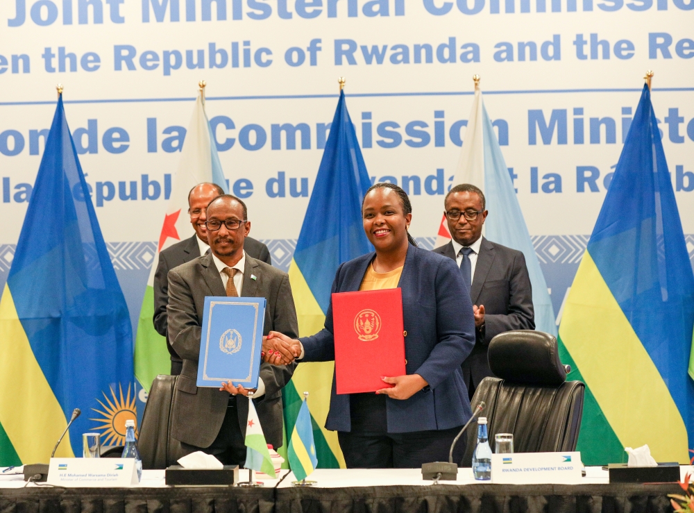 Rwanda Development Board Chief Executive Officer Clare Akamanzi exchanges documents during the signing event . The three agreements include diplomatic training, agriculture and tourism.