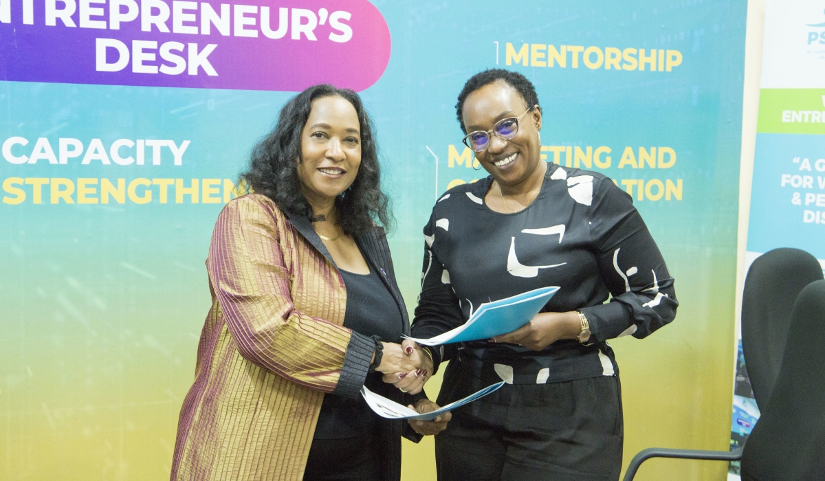 Pamela Coke-Hamilton, Executive Director of ITC and Therese Sekamana, Chairperson of PSF Specialized Cluster exchange documents during the signing ceremony in Kigali on May 9. Emmanuel Dushimirimana