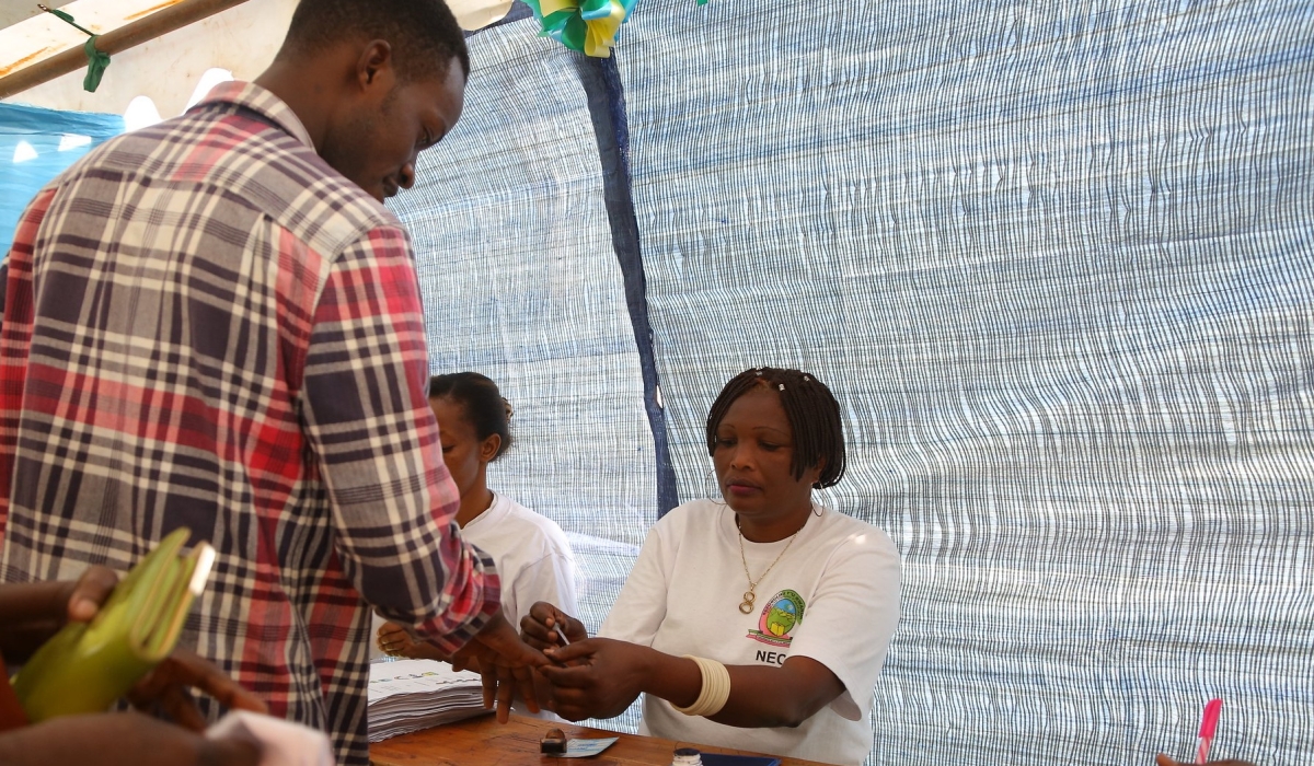 A voter talks to the electoral commission&#039;s volunteers before casting his vote during parliamentary elections in 2018. MPs adopted some revisions like the synchronization of presidential and parliamentary elections.