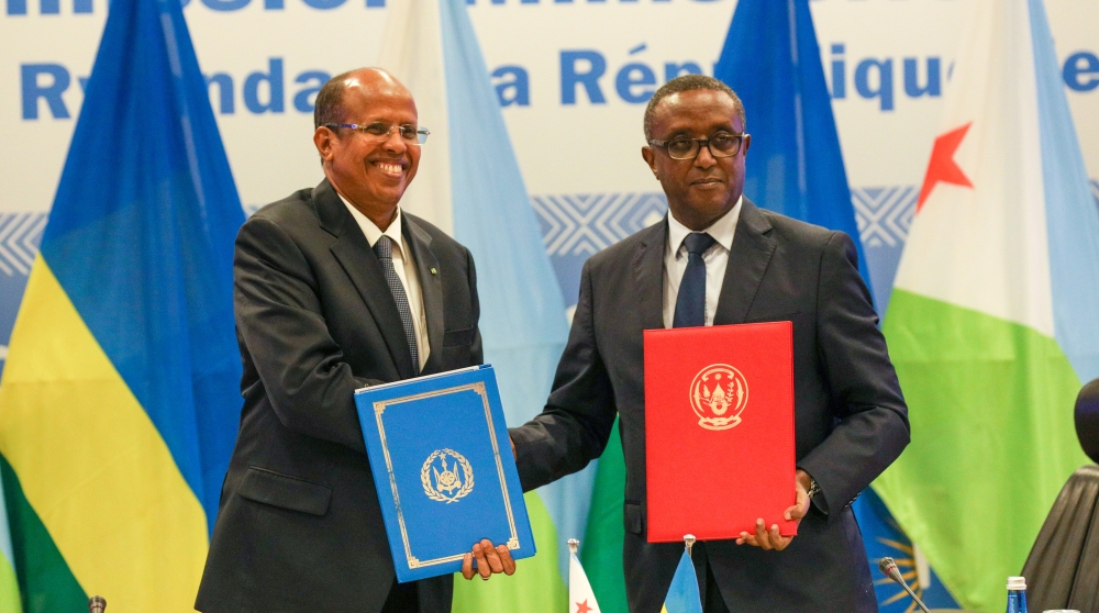 The Minister of Foreign Affairs and International Cooperation, Dr Vincent Biruta (right), and his Djiboutian counterpart Mahamoud Ali Youssouf exchange documents during the signing of three bilateral agreements between Rwanda and
Djibouti in Kigali on Wednesday, May 10. The deals cover diplomatic training, agriculture and tourism. Photo: Dan Gatsinzi.