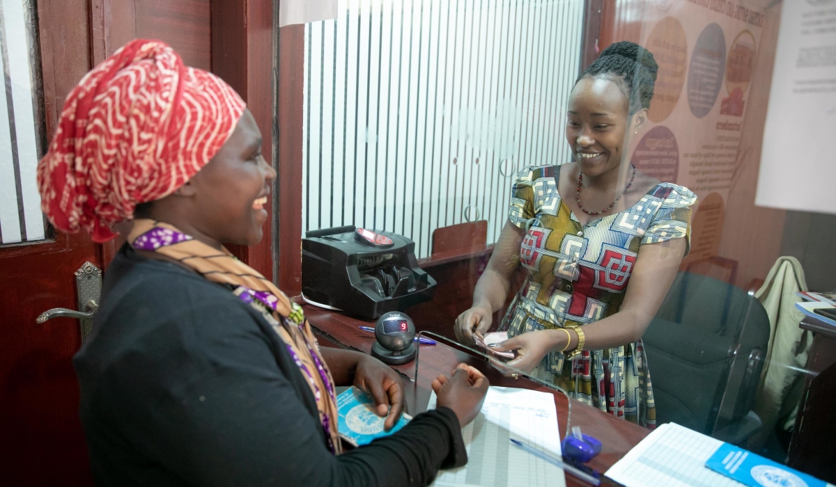 A teller serves a customer at Kacyiru Umurenge SACCO. By June, the government will start the long-awaited automation of the 416 Umurenge Savings and Credit Cooperatives. Photo: Craish Bahizi.