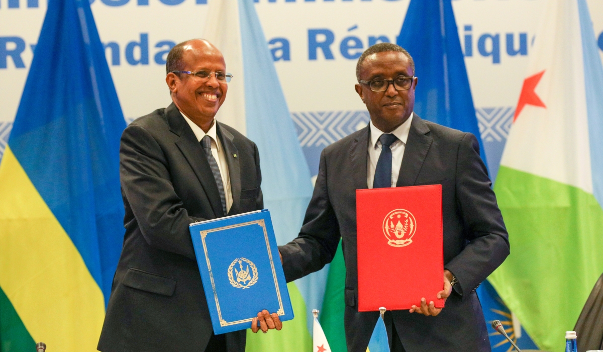 The Minister of Foreign Affairs and International Cooperation, Dr Vincent Biruta (right), and his Djiboutian counterpart Mahamoud Ali Youssouf exchange documents during the signing of three bilateral agreements between Rwanda and
Djibouti in Kigali on Wednesday, May 10. The deals cover diplomatic training, agriculture and tourism. Photo: Dan Gatsinzi.