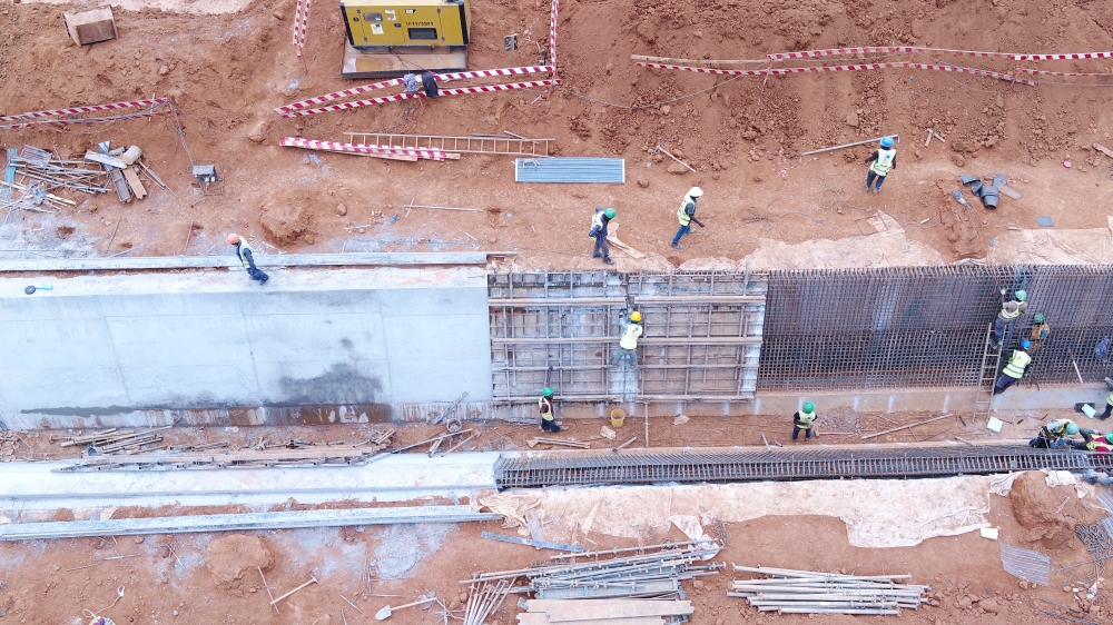 Men at work on drainage concrete works. Aviation Travel and Logistics (ATL).