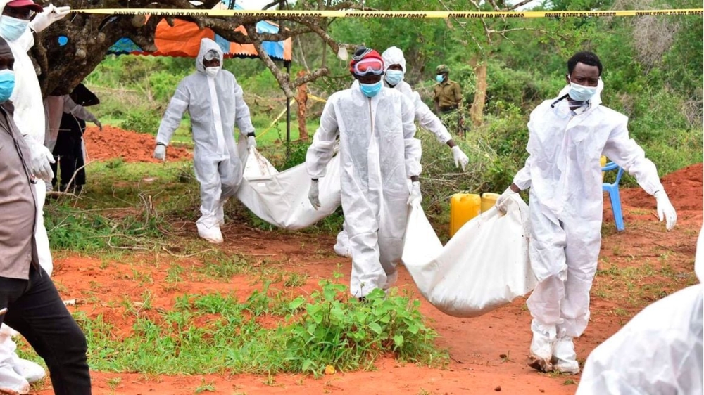 Investigators carrying bodies exhumed from graves at Shakahola village in Malindi, Kenya on April 22, 2023. Photo: NMG