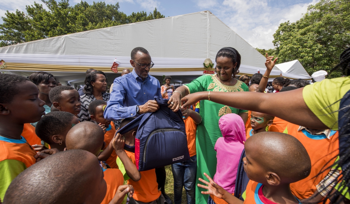 President Kagame and First Lady Jeannette Kagame present Christmas gifts to children at Village Urugwiro.