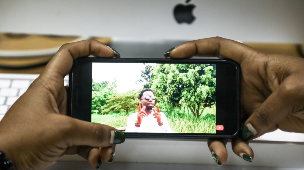 A social media user watching a video of a Rwandan YouTuber. Photo by Dan Gatsinzi