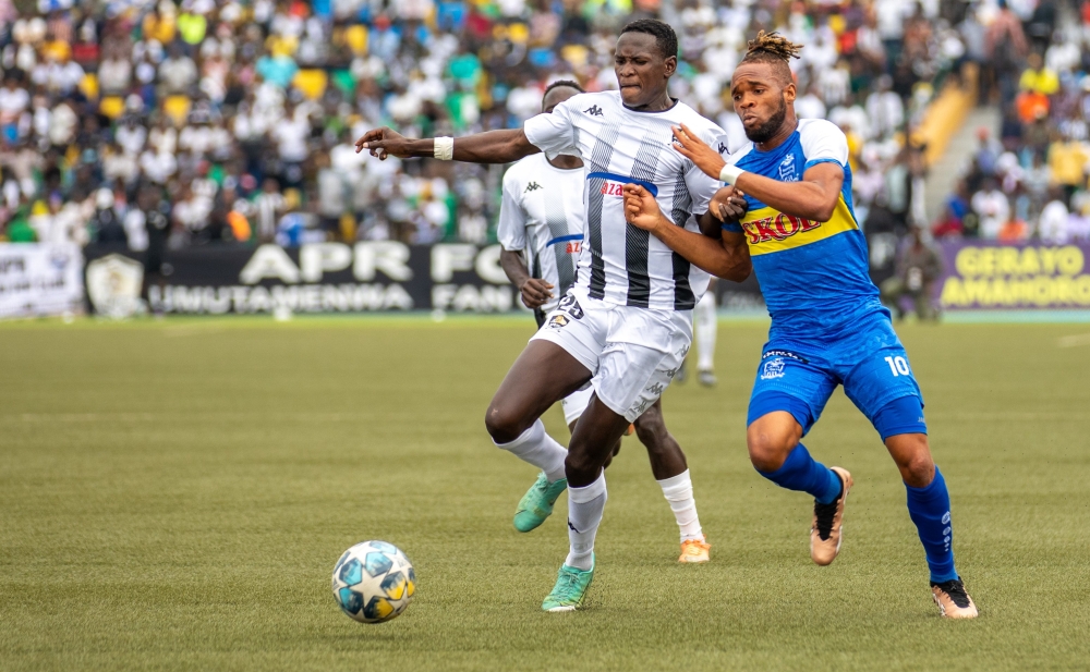 APR FC winger Fitina Ombolenga vies for the ball against Rayon Sports striker Onana during a past derby at Huye Stadium. Arch rivals APR and Rayon Sports will lock horns in Peace Cup final at Huye Stadium on June 3. Olivier Mugwiza