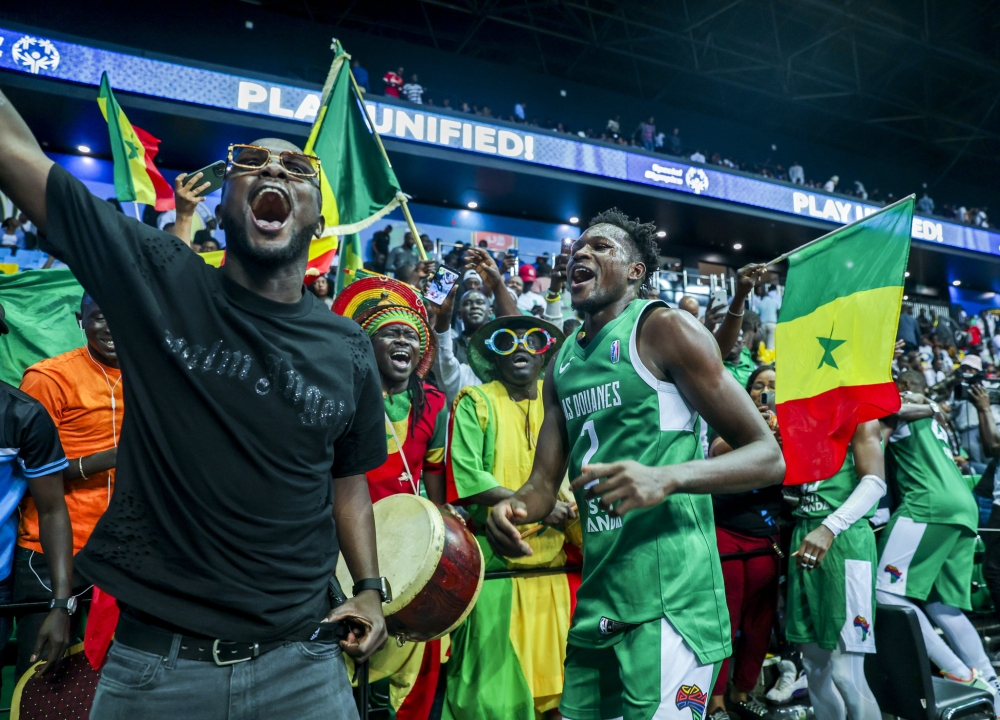 AS Douanes players and fans celebrate the crucial win as they stun Angola’s Petro de Luanda 92-86 in the semi-finals on Wednesday at BK Arena. All Photos by Olivier Mugwiza.