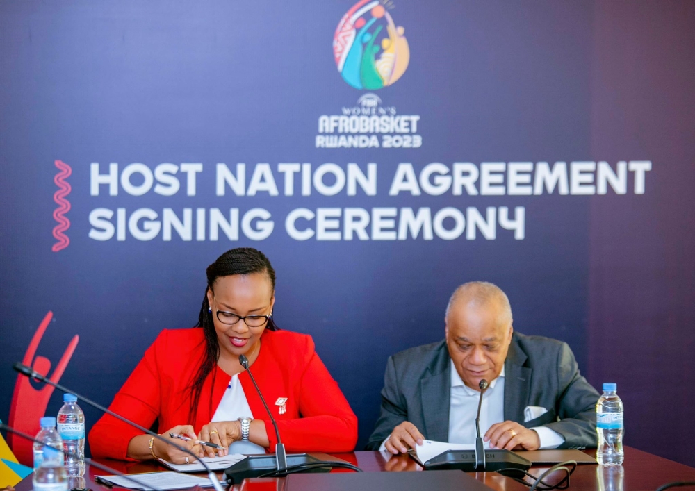 Sports Minister Aurore Mimosa Munyangaju and Alphonse Bilé, the FIBA Africa Regional Director sign the agreement in Kigali  in Kigali on Thursday, May 25. Courtesy