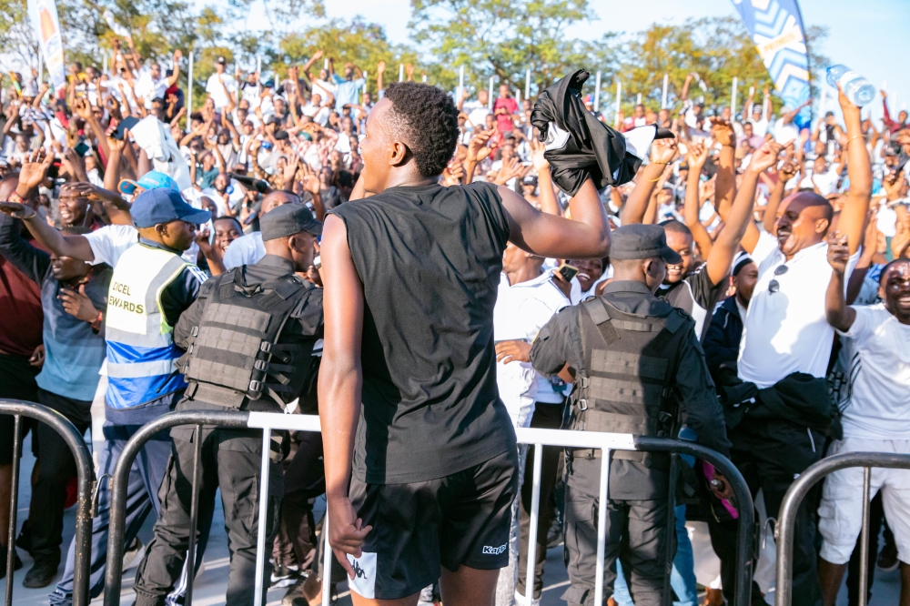 APR FC striker Innocent Nshuti with the Army side supporters as they celebrate the 21st league title, their fourth in a row at Kigal Pele Stadium on Sunday 