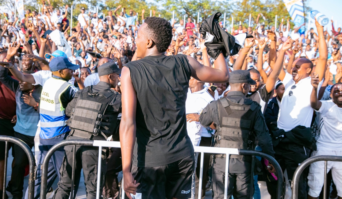 APR FC striker Innocent Nshuti with the Army side supporters as they celebrate the 21st league title, their fourth in a row at Kigali Pele Stadium on Sunday. Photo by Craish Bahizi
