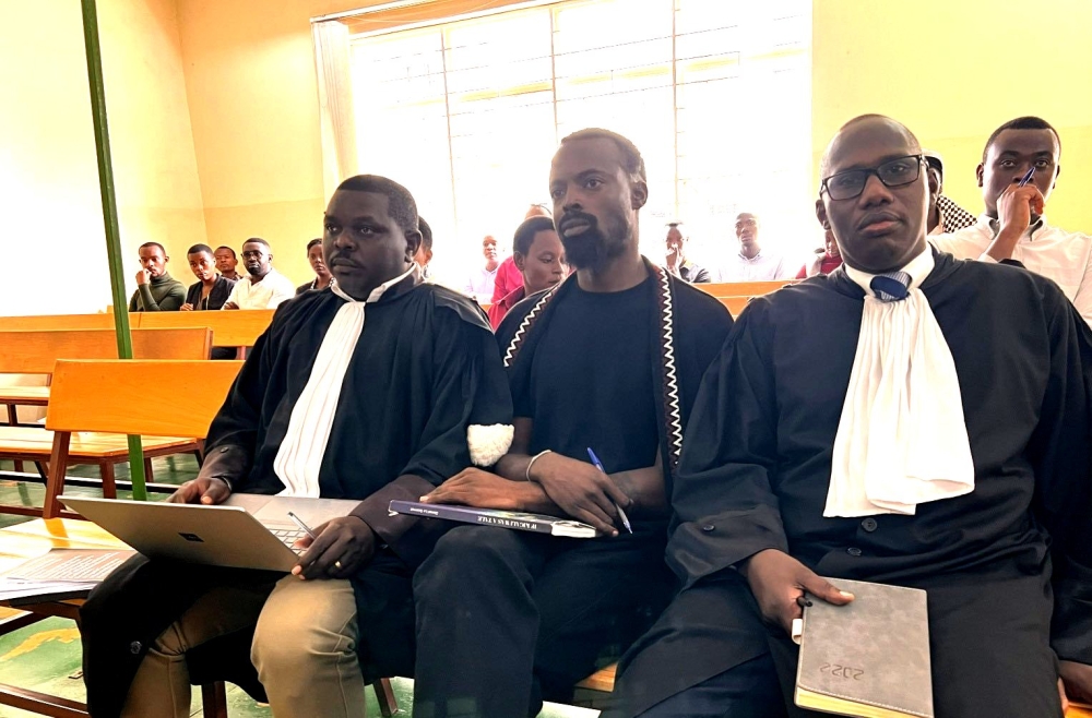 Moses Turahirwa with his two lawyers, Irene Bayisabe and Frank Asiimwe during a hearing session on May 10. Courtesy