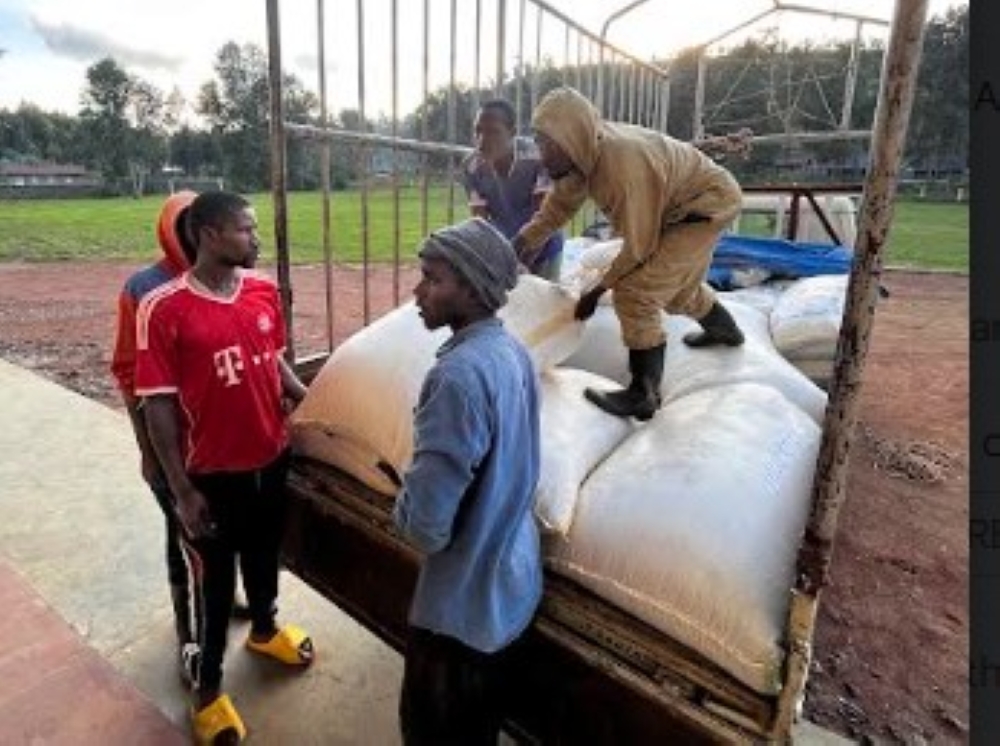 Workers offload some food stuff that will be distributed to residents affected by disasters in Western province in Nyabihu District on May 3. Courtesy
