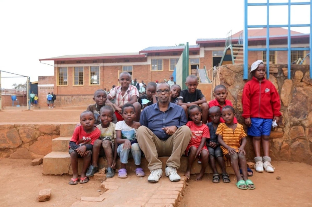 Damas Gisimba Mutezintare sits with some children who lived at the Gisimba orphanage in Nyamirambo - Kigali. File
