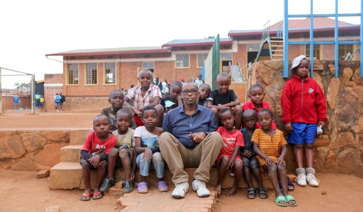 Damas Gisimba Mutezintare sits with some children who lived at the Gisimba orphanage in Nyamirambo - Kigali. File