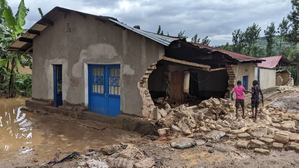 Two children walk around one of 6000 houses that were distroyed by disasters on May 3. The government and Imbuto Foundation launch a Remedial and Catch-up Programme aimed at assisting students who were displaced by disasters. 