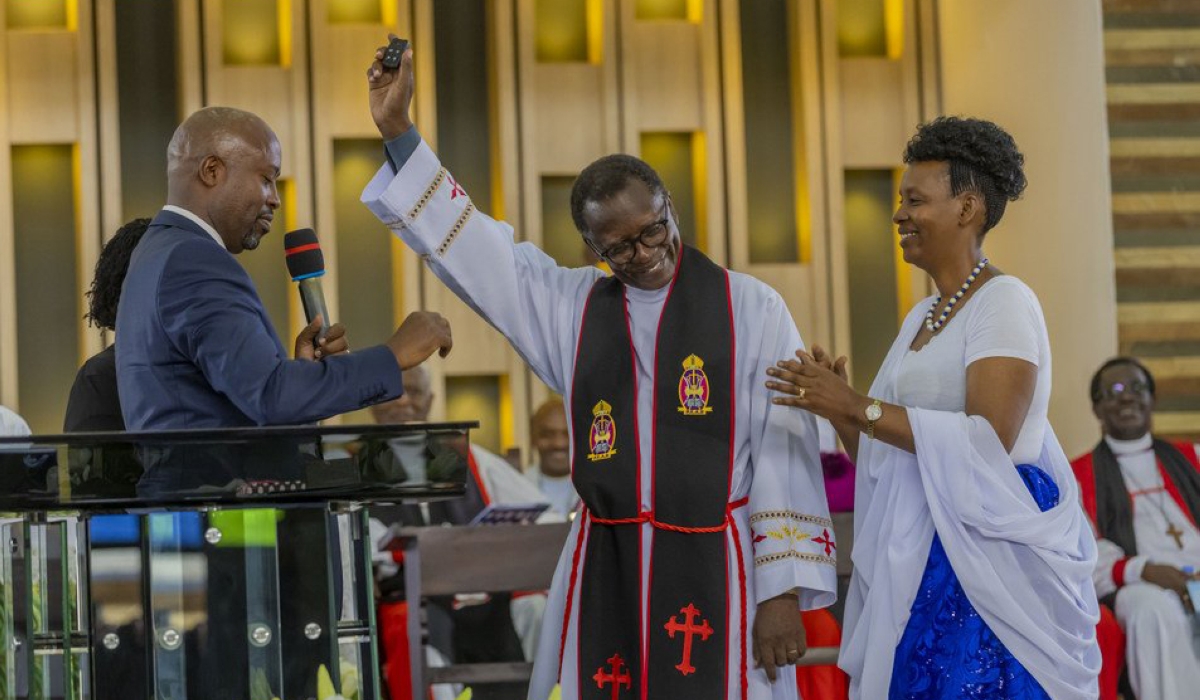 Sam Nkurunziza, the head of EAR Remera congregation (left), handing over car keys to the retiring Reverend Canon Antoine Rutayisire (center), as the latter’s wife, Penina Kayitesi, claps, on Sunday, June 4. Upon his retirement, Christians gifted Rutayisire with a brand new Toyota Fortuner 2023 as a sign of gratitude. Courtesy