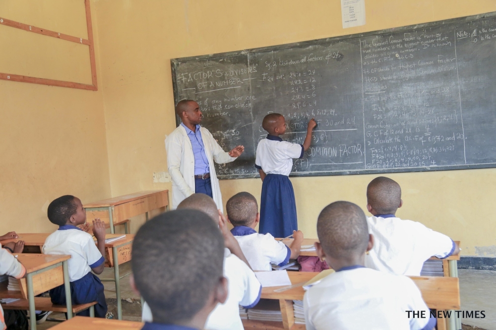 A teacher inspects how his student does the exercise at SOS Kacyiru. Socrates asserts that “Education is the kindling of a flame, not the filling of a vessel”.Photo by Craish Bahizi