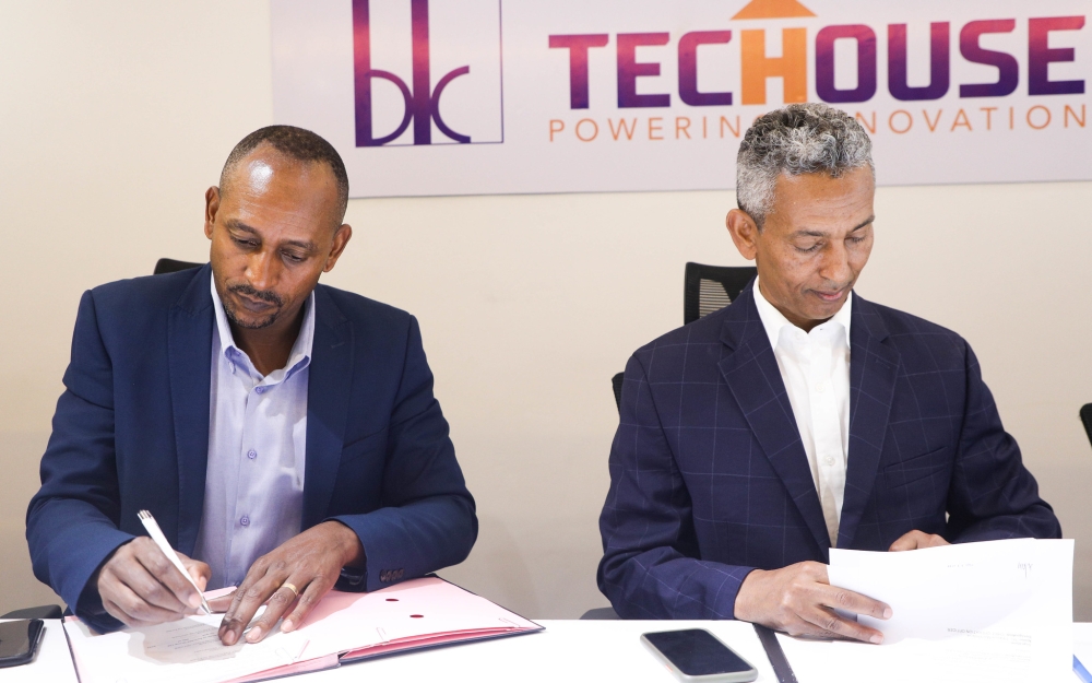 Claude Munyangabo, CEO of BK TecHouse and Mulualem Syoum, Chief Executive Officer of AeTrade Group sign the Memorandum of Understanding  at BK TecHouse headquarters on Wednesday, June 7. All photos by Craish Bahizi