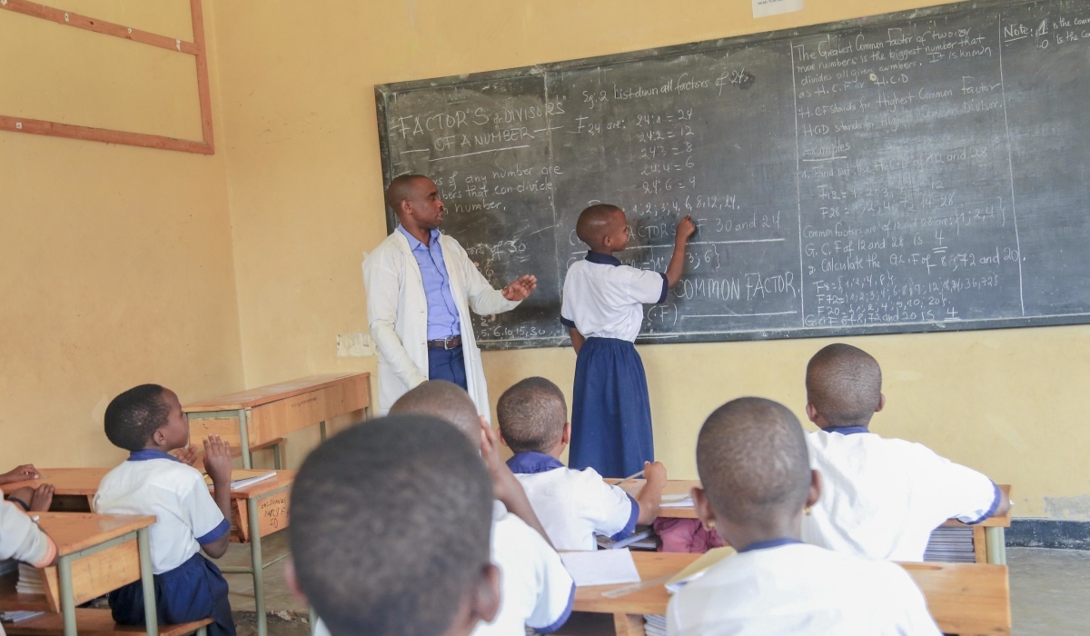 A teacher inspects how his student does the exercise at SOS Kacyiru. Socrates asserts that “Education is the kindling of a flame, not the filling of a vessel”.Photo by Craish Bahizi