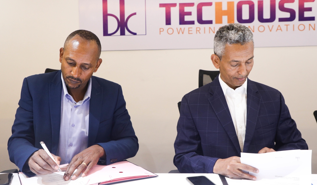 Claude Munyangabo, CEO of BK TecHouse and Mulualem Syoum, Chief Executive Officer of AeTrade Group sign the Memorandum of Understanding  at BK TecHouse headquarters on Wednesday, June 7. All photos by Craish Bahizi