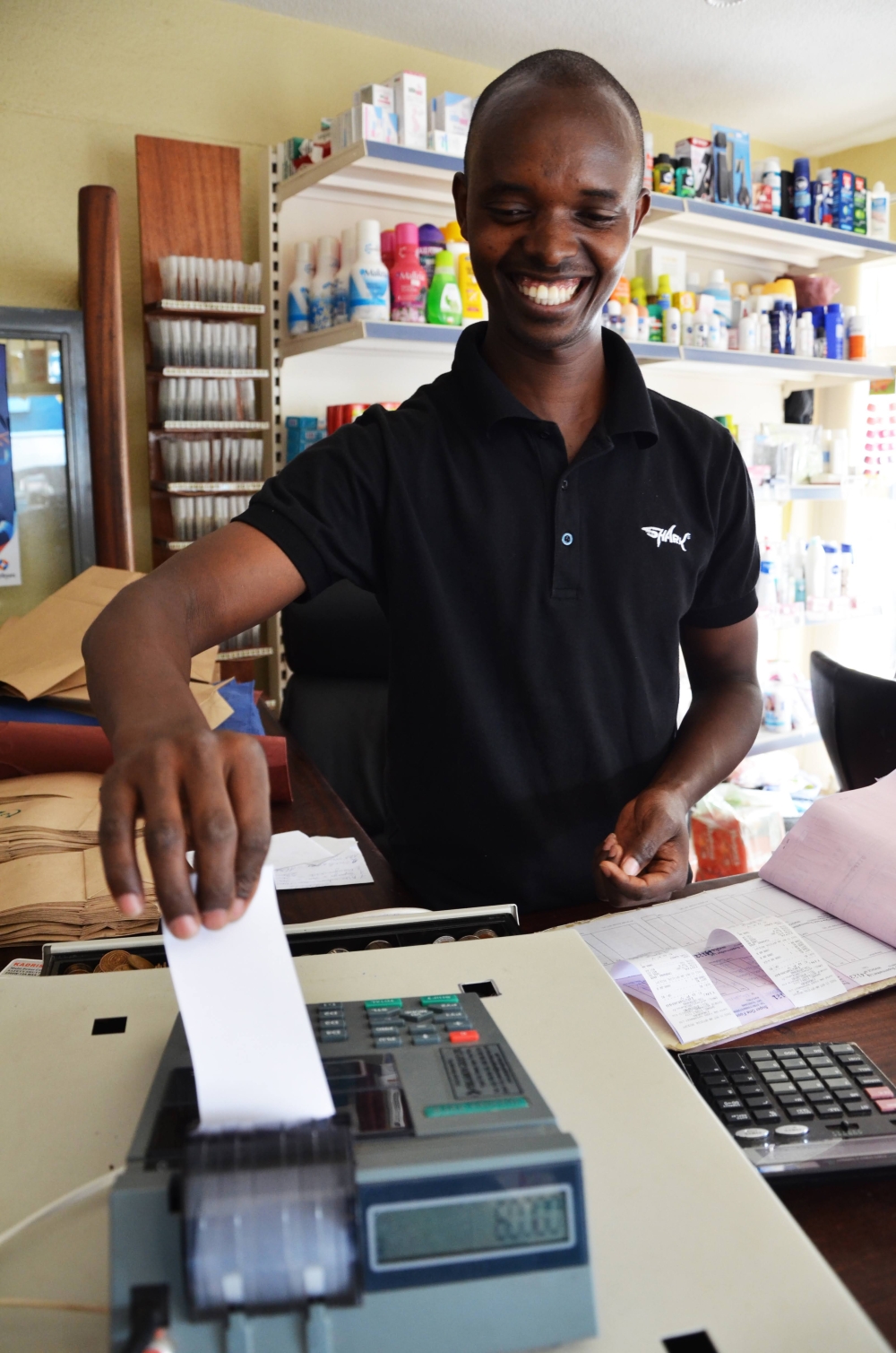 A vendor using EBM in his shop at Kacyiru. The Rwanda Revenue Authority (RRA) has three months to bring the tax management system into compliance with the provisions of the law. Sam Ngendahimana