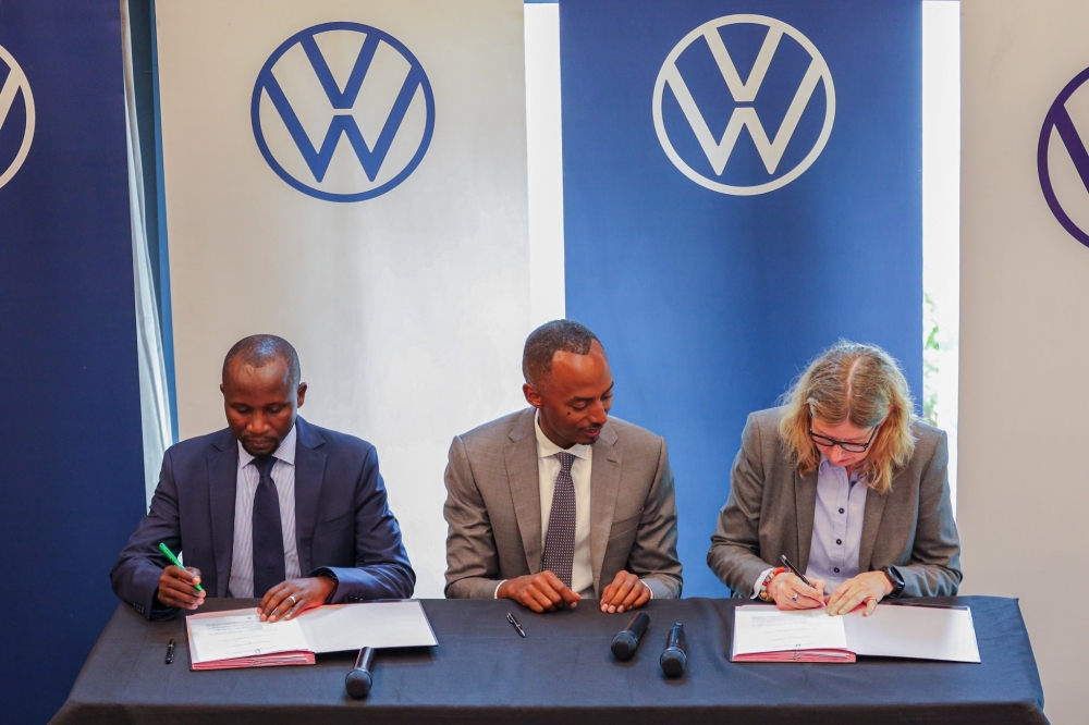  Agriculture Minister Ildephonse Musafiri (L) and Martina Biene, Chairperson and Managing Director of Volkswagen South Africa (R), sign the electric tractor related MoU, on June 9, 2023, in Kigali. Biene is flanked by Serge Kamuhinda, CEO of Volkswagen Rwanda (Courtesy).